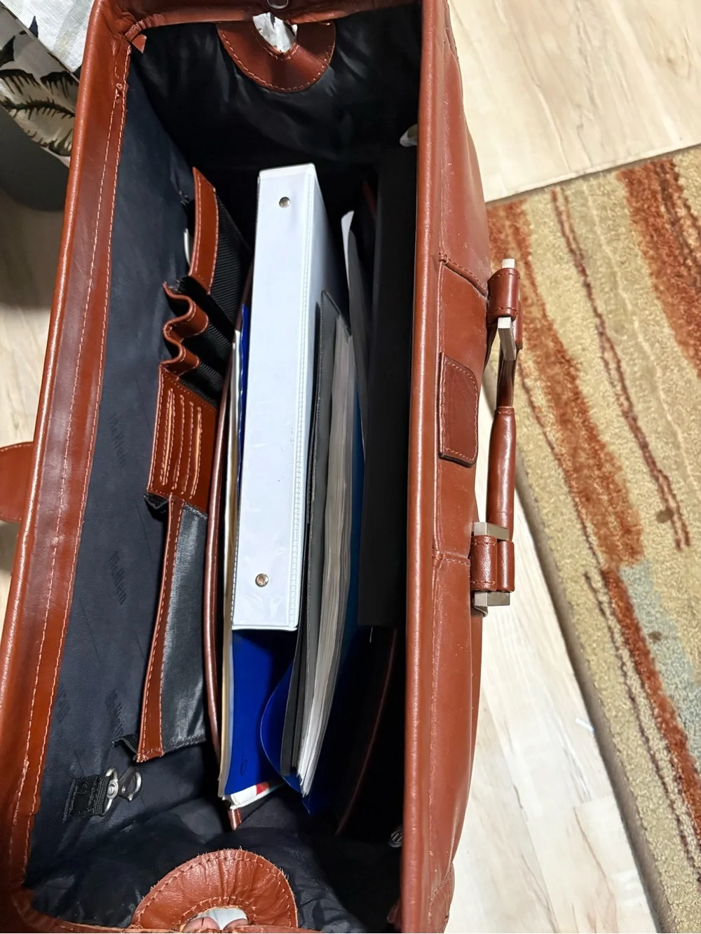 Litagator leather briefcase with security features and sturdy handles.